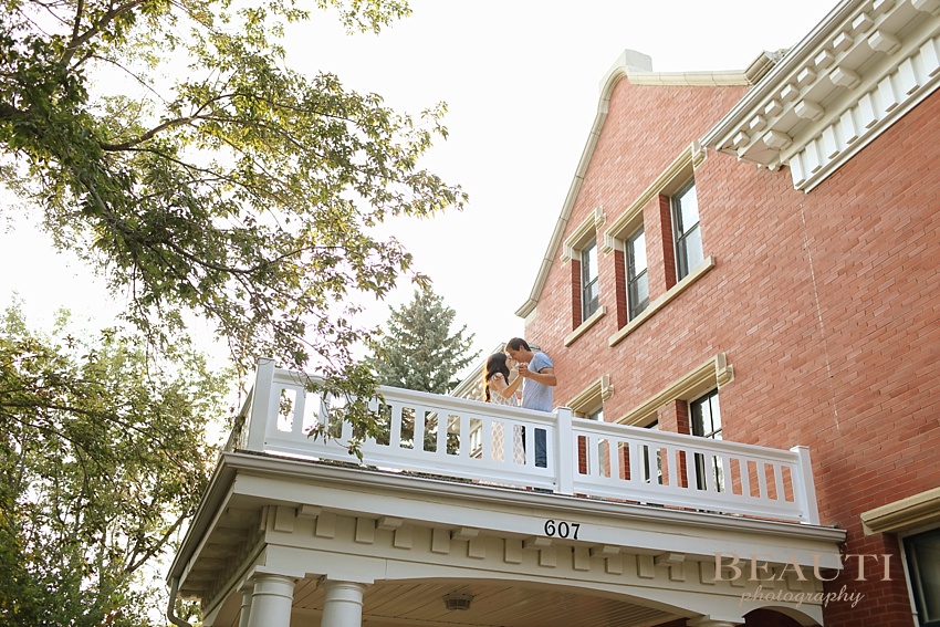 Weyburn engagement photographer newly engaged Sask wedding photographer heritage Eaglesham house balcony photo