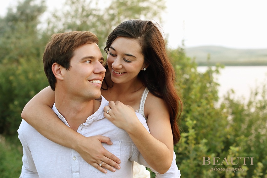 Weyburn engagement photographer newly engaged Sask wedding photographer Nickle Lake summer engagement session sunset smiles photo
