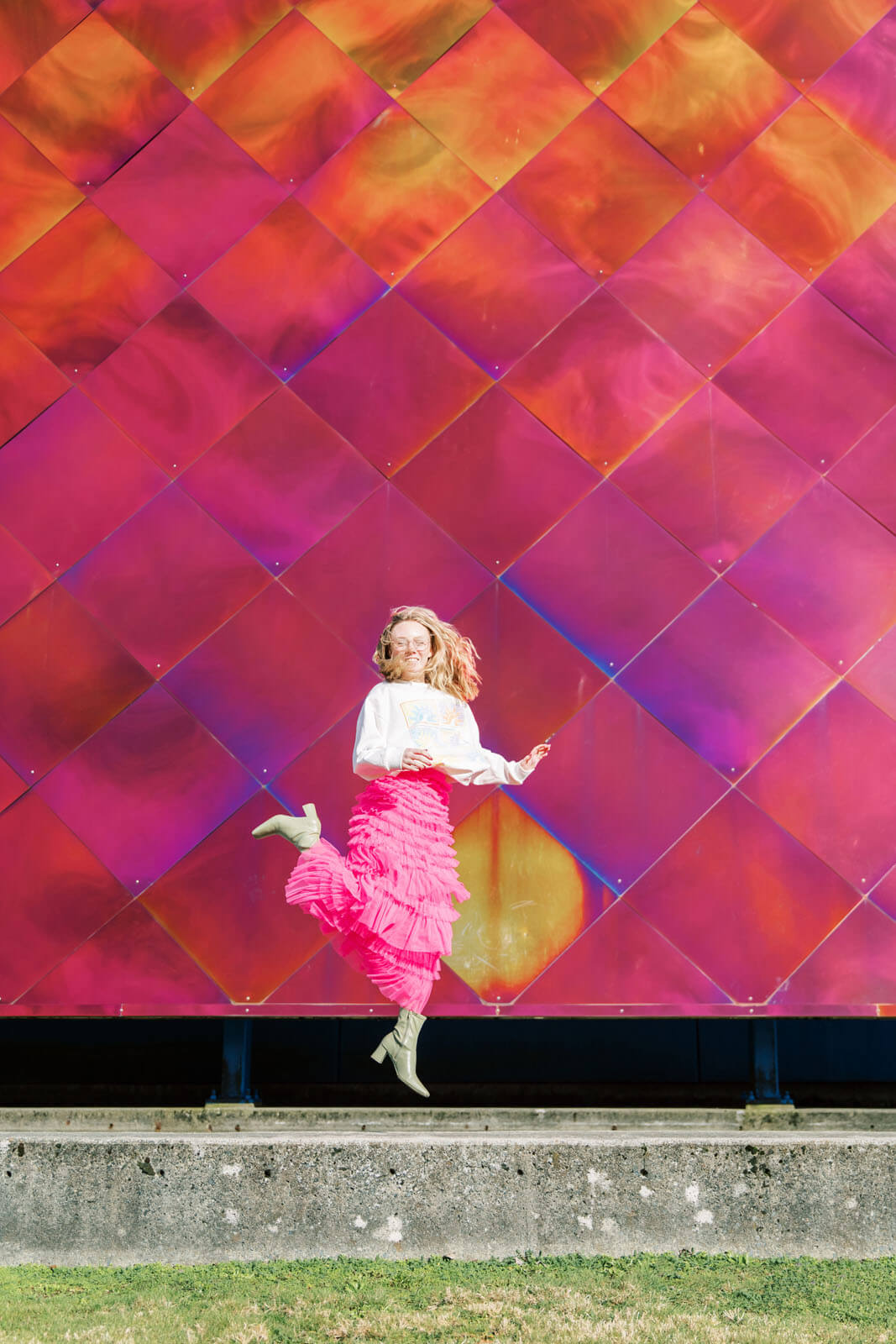 Jenelle Quigley Photography Nanaimo Vancouver Island British Columbia lifestyle photographer pink wall pink skirt jumping young lady Happy Love Day