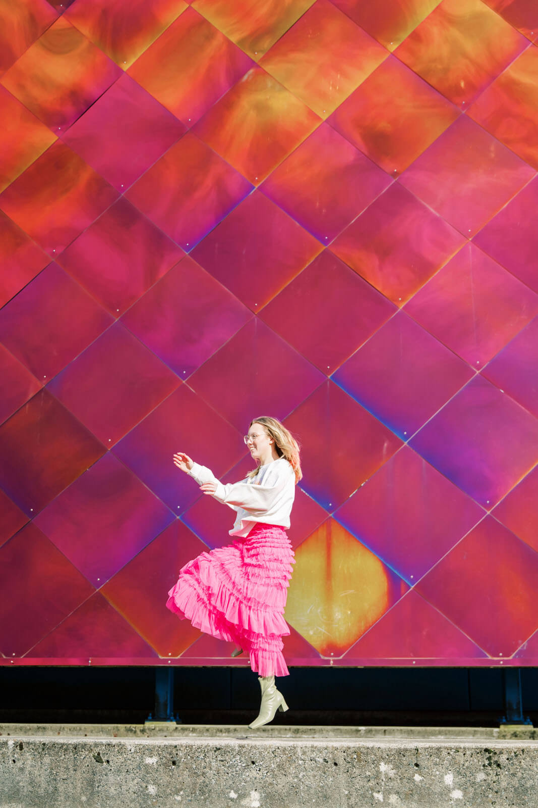 Jenelle Quigley Photography Nanaimo Vancouver Island British Columbia lifestyle photographer pink wall pink skirt jumping young lady Happy Love Day