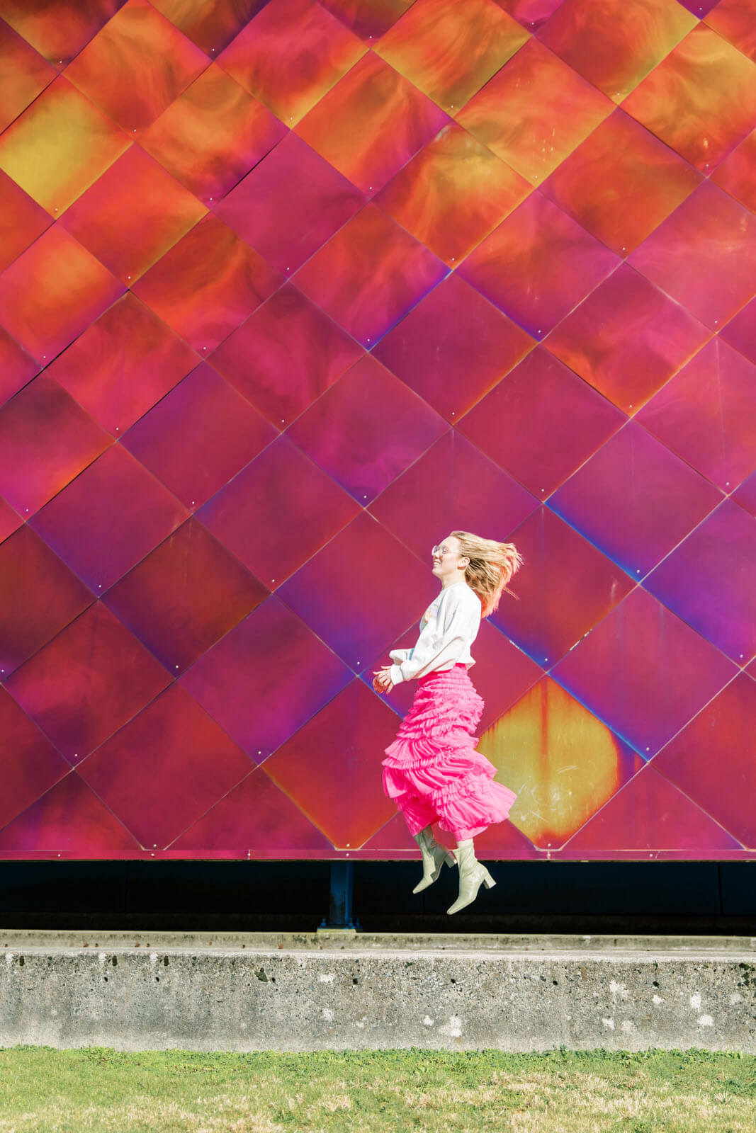 Jenelle Quigley Photography Nanaimo Vancouver Island British Columbia lifestyle photographer pink wall pink skirt jumping young lady Happy Love Day