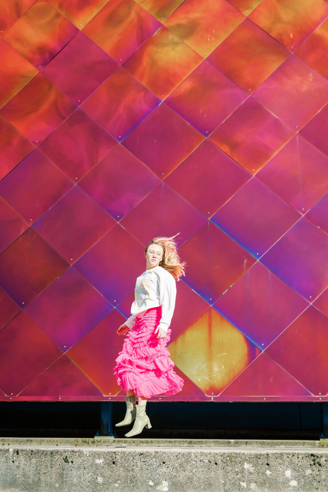 Jenelle Quigley Photography Nanaimo Vancouver Island British Columbia lifestyle photographer pink wall pink skirt jumping young lady Happy Love Day