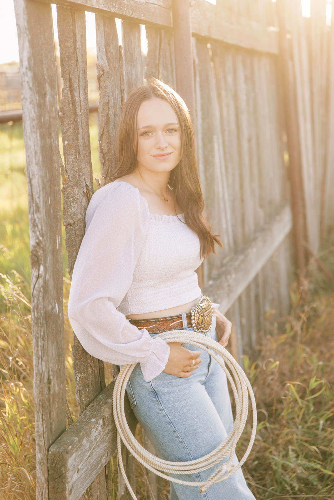 Jenelle Quigley Photography Saskatchewan lifestyle photographer fall sunset class of 2024 western belt buckle lariat roping