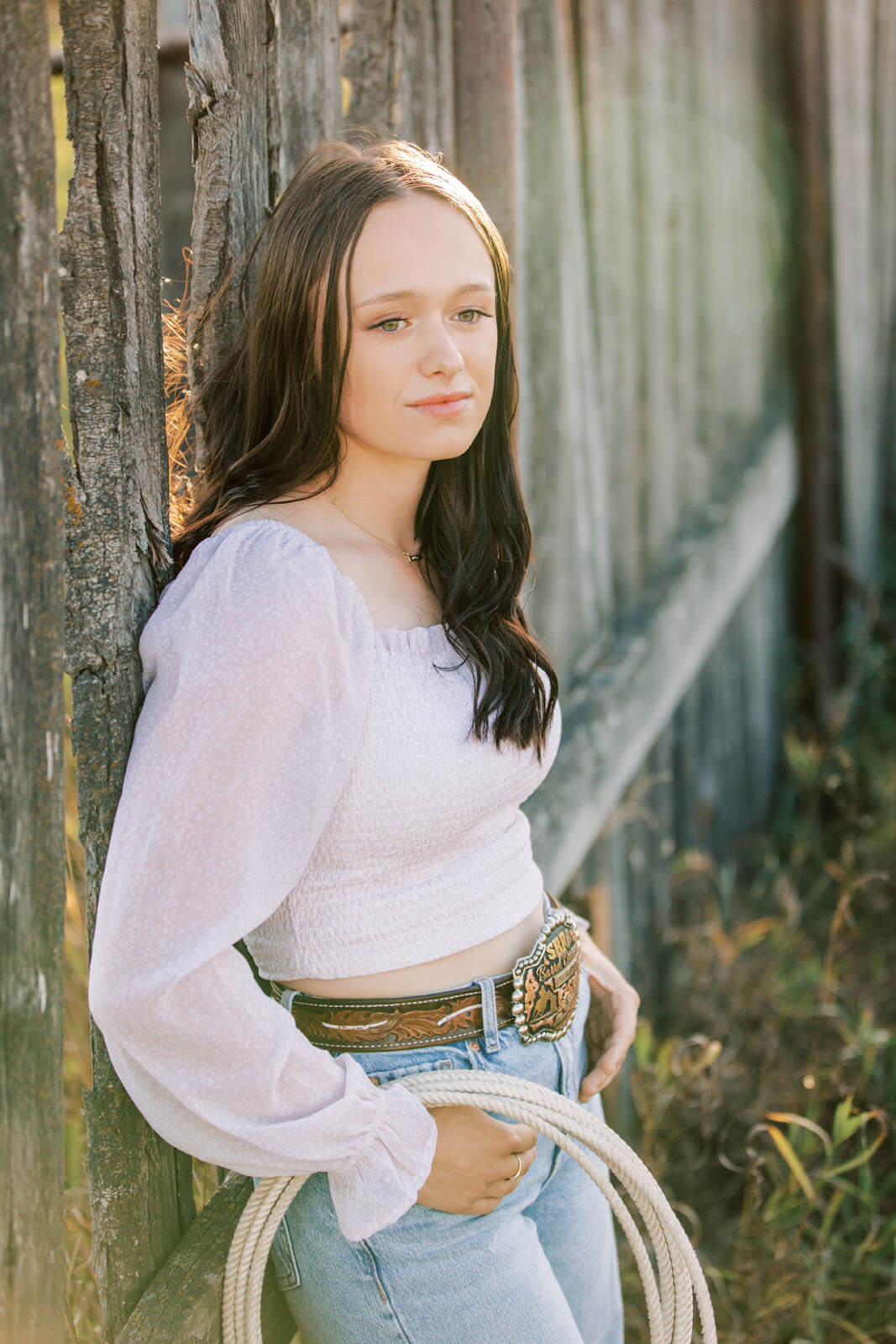 Jenelle Quigley Photography Saskatchewan lifestyle photographer fall sunset class of 2024 western belt buckle lariat roping